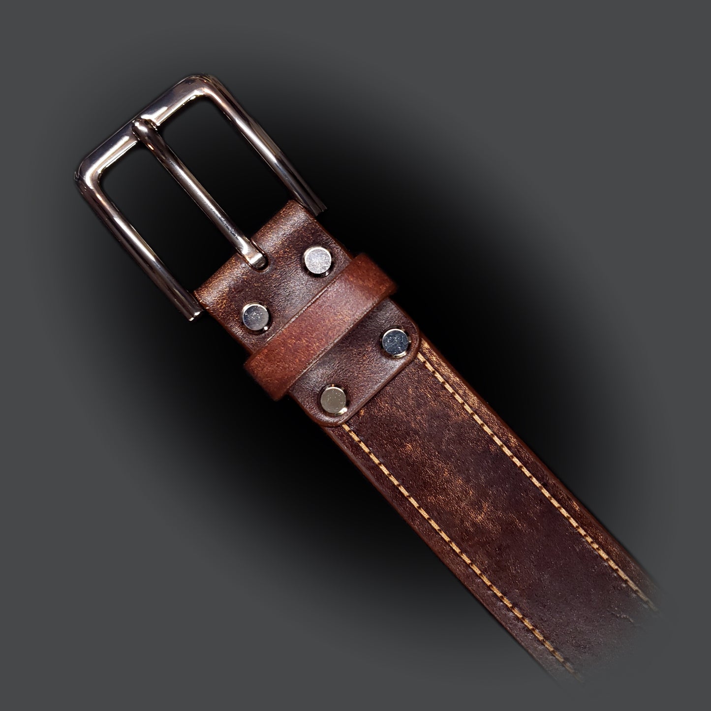 Brown leather belt with light brown stitching and a silver buckle.