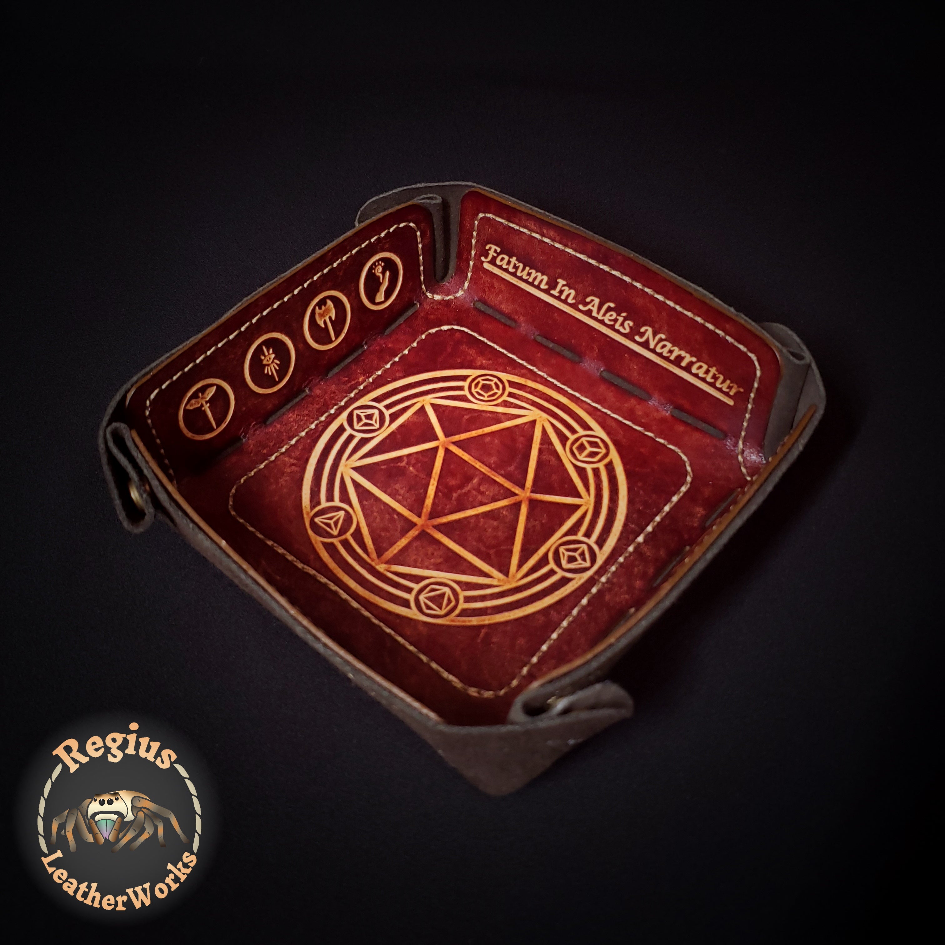 Brown leather dice tray embossed with a dice shaped rune circle, class symbols and Latin text.