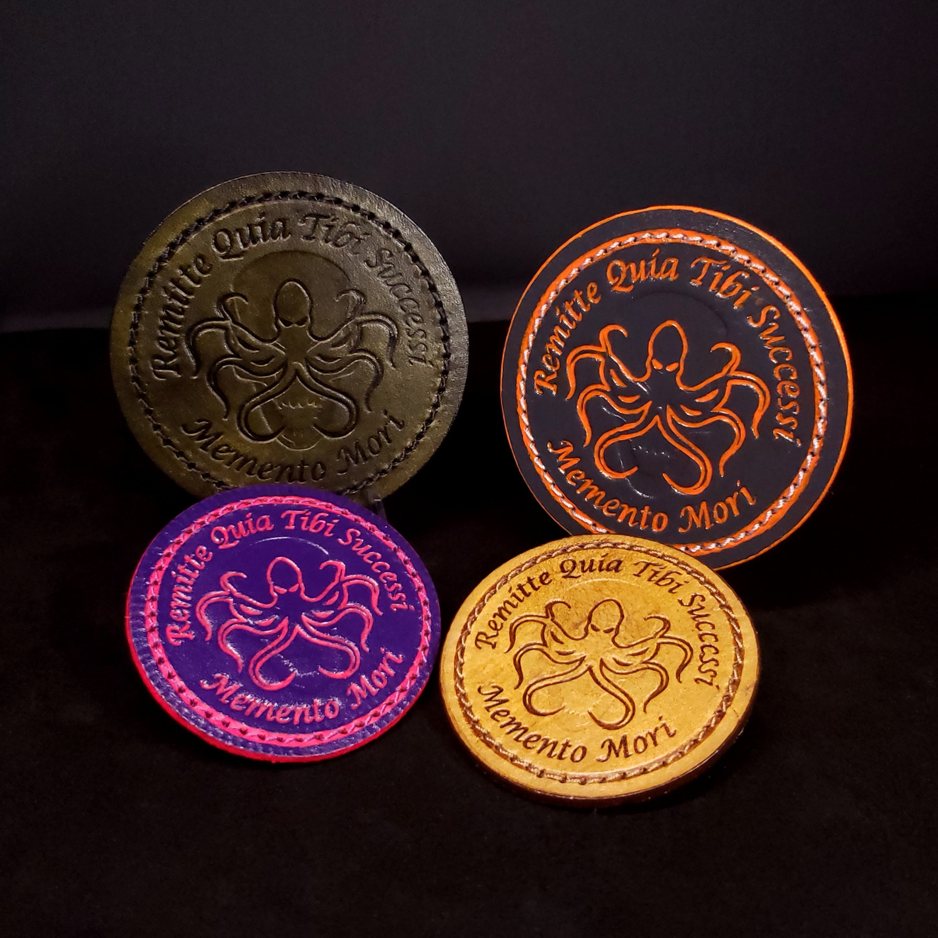 Four multi-colored circle velcro patches depicting an octopus and skull