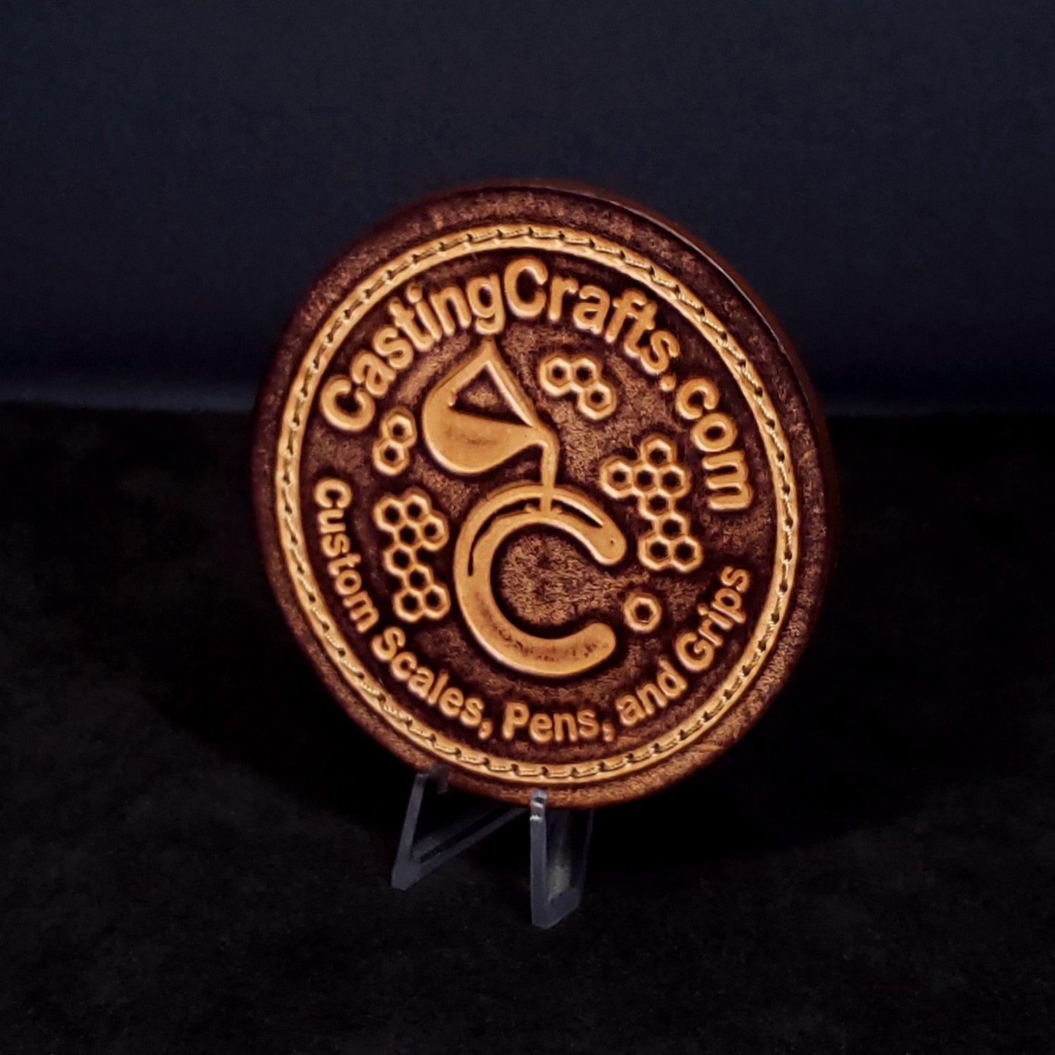 round brown leather patch with a custom log and text that says "casting crafts dot com"