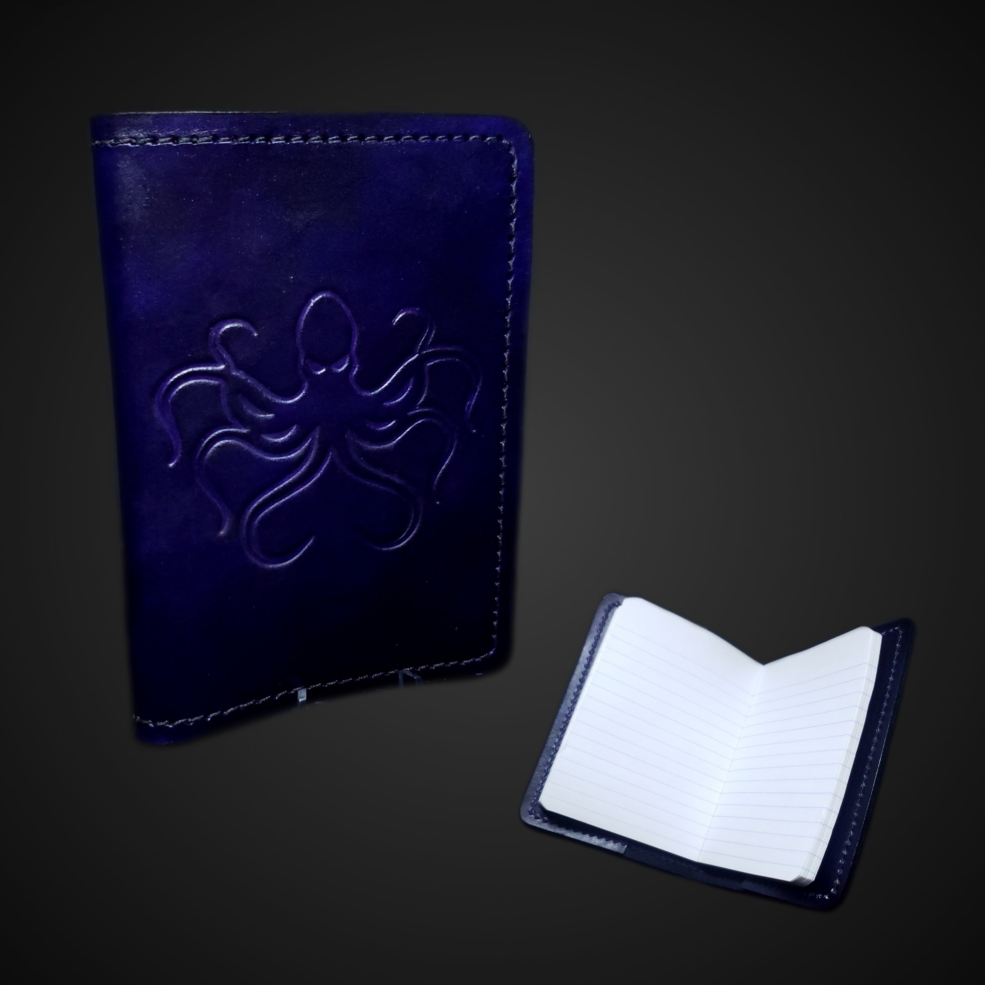 Purple leather miniature composition book cover embossed with an octopus graphic.