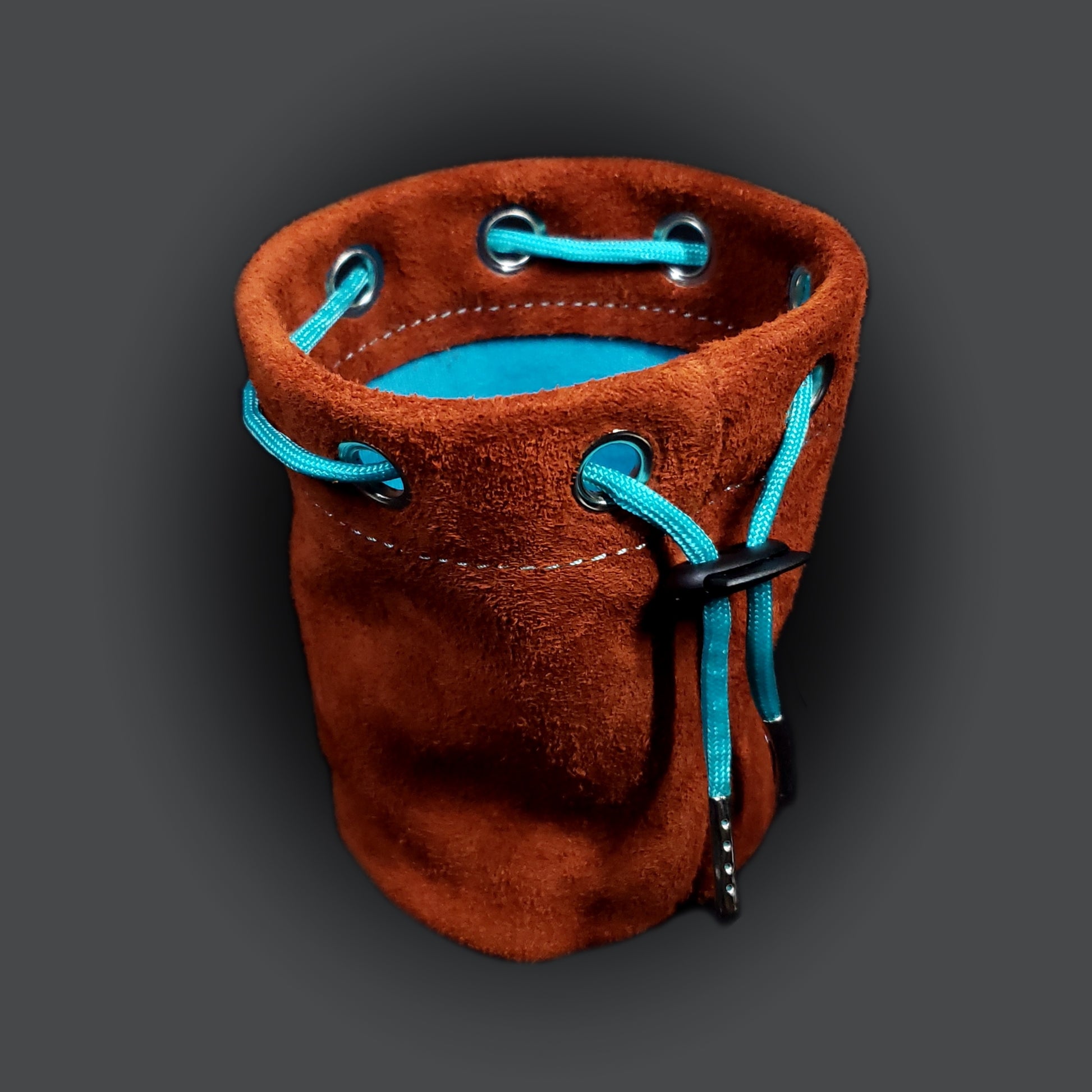 Light brown suede leather pouch with a light blue cloth interior and light blue drawstring.