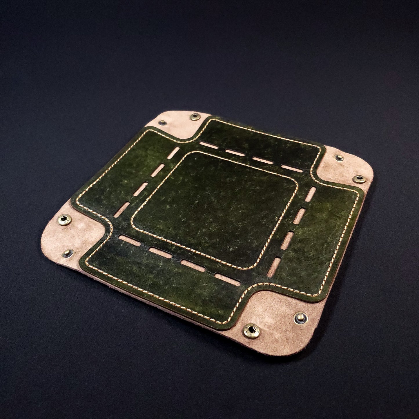 Olive green leather dice tray with brown stitching and bronze buttons, opened and laid flat.
