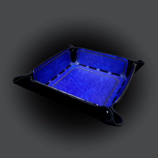 Blue leather dice tray with black stitching and gun metal buttons, viewed from the front.