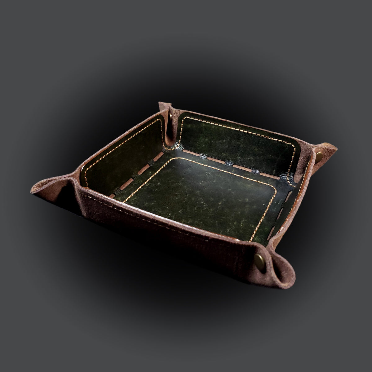 Olive green leather dice tray with light brown stitching and bronze buttons, viewed from the front.