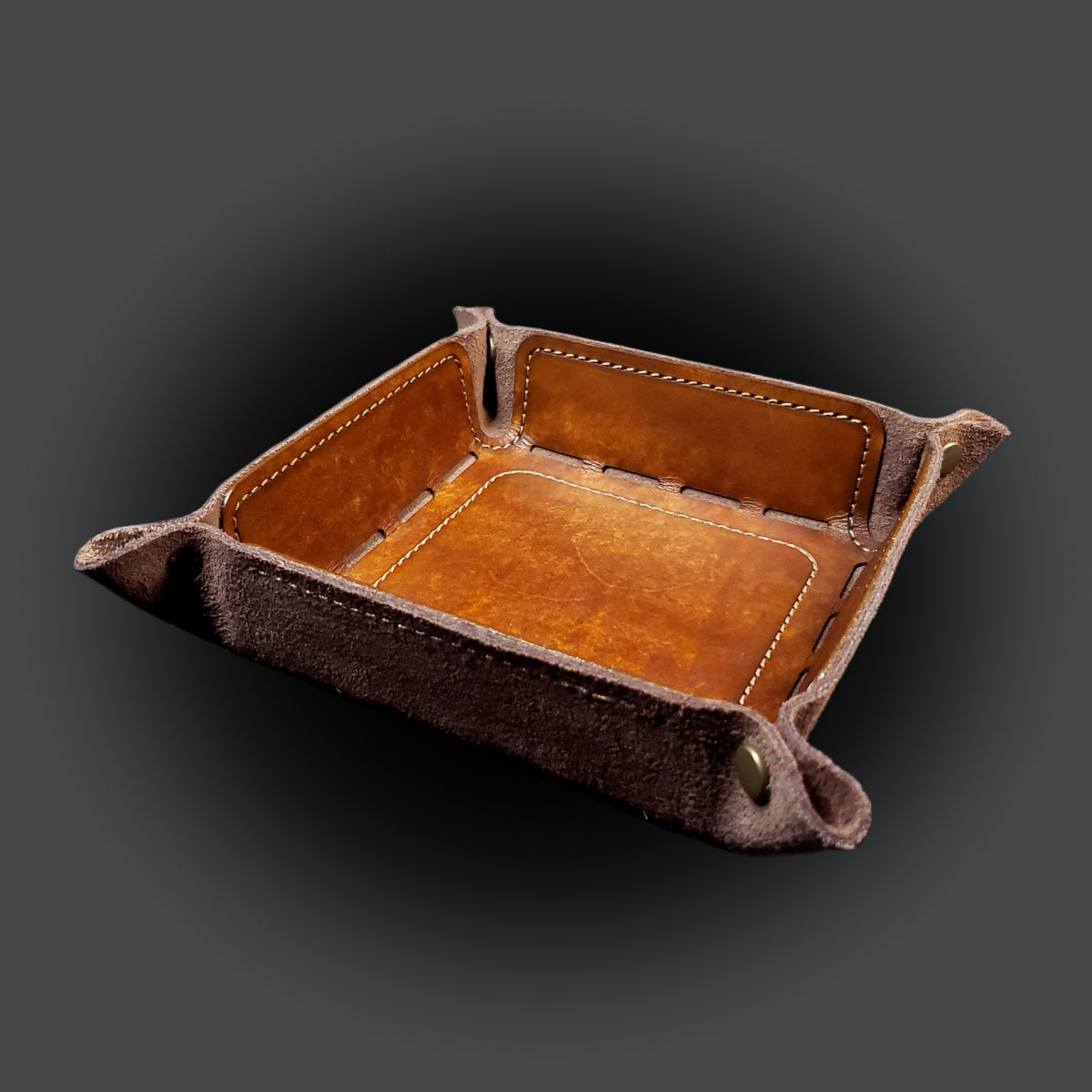 Walnut brown leather dice tray with light brown stitching and bronze buttons, viewed from the front.