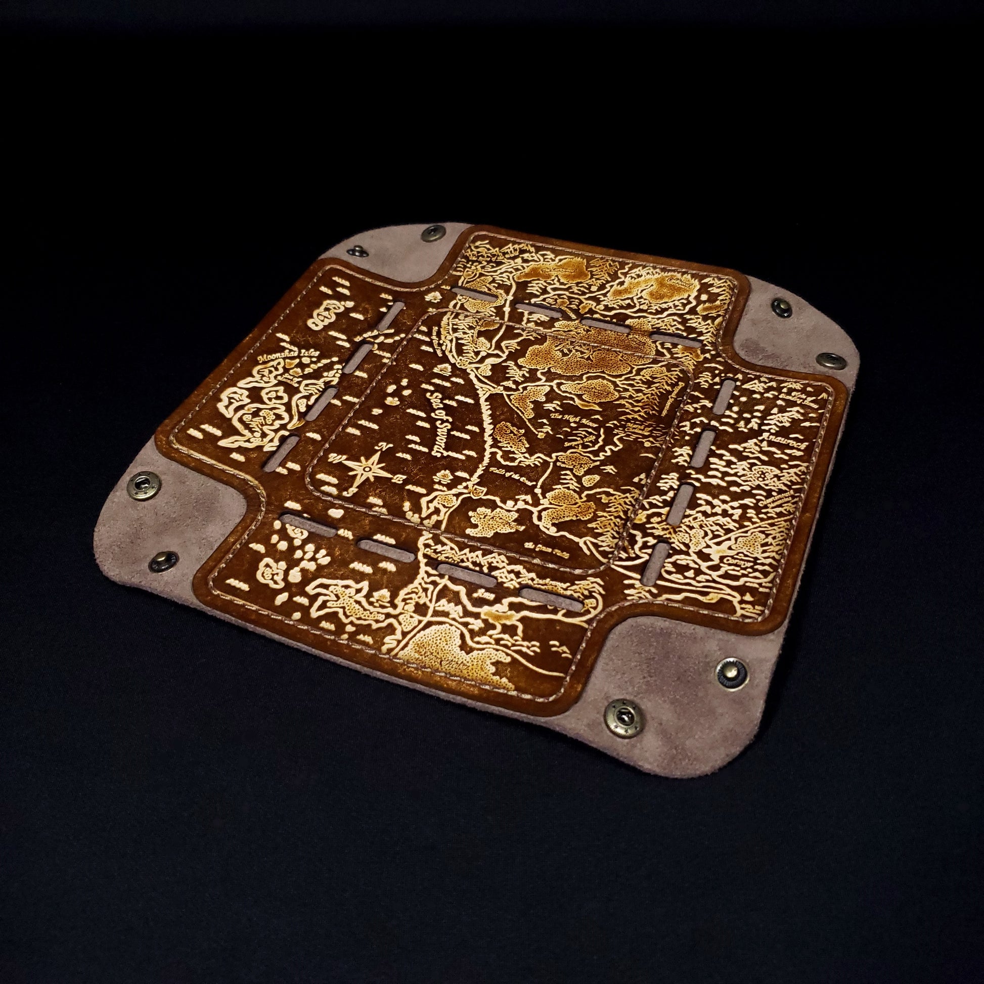 Brown leather dice tray decorated with a fantasy map of the sword coast while opened flat.