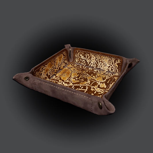 Brown leather dice tray decorated with a fantasy map  of the sword coast, viewed from the side.