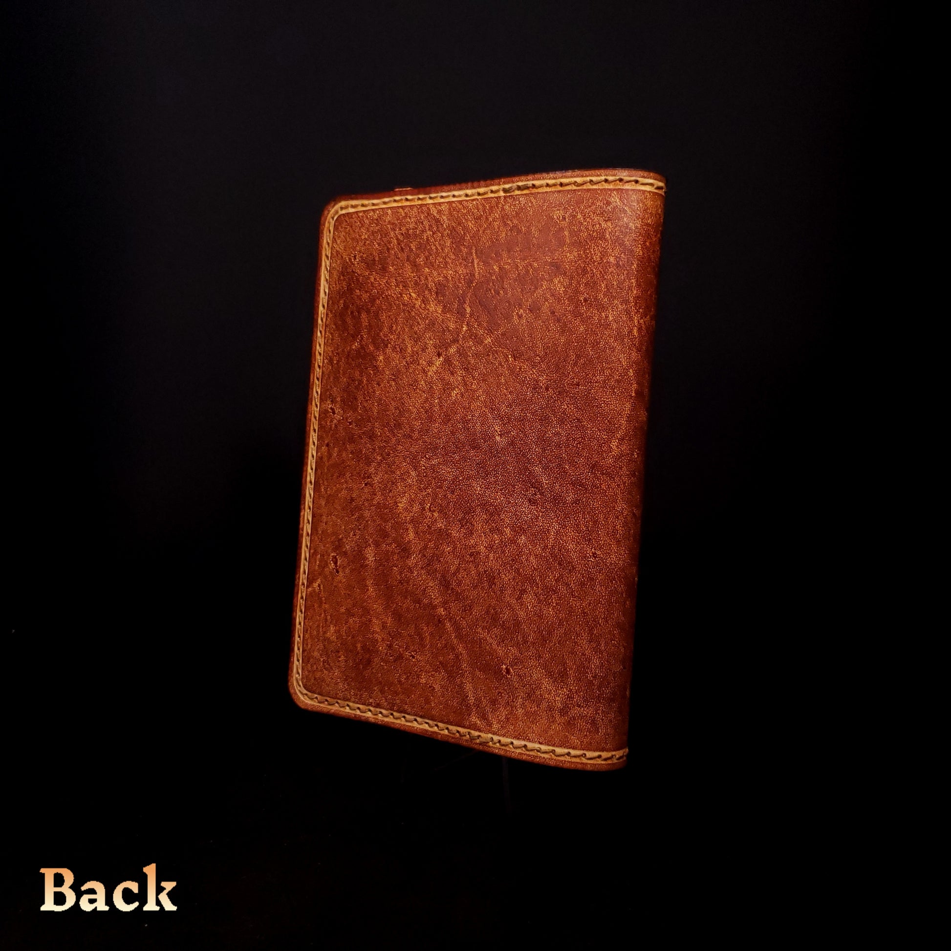 Brown leather notebook cover, viewed from the back.