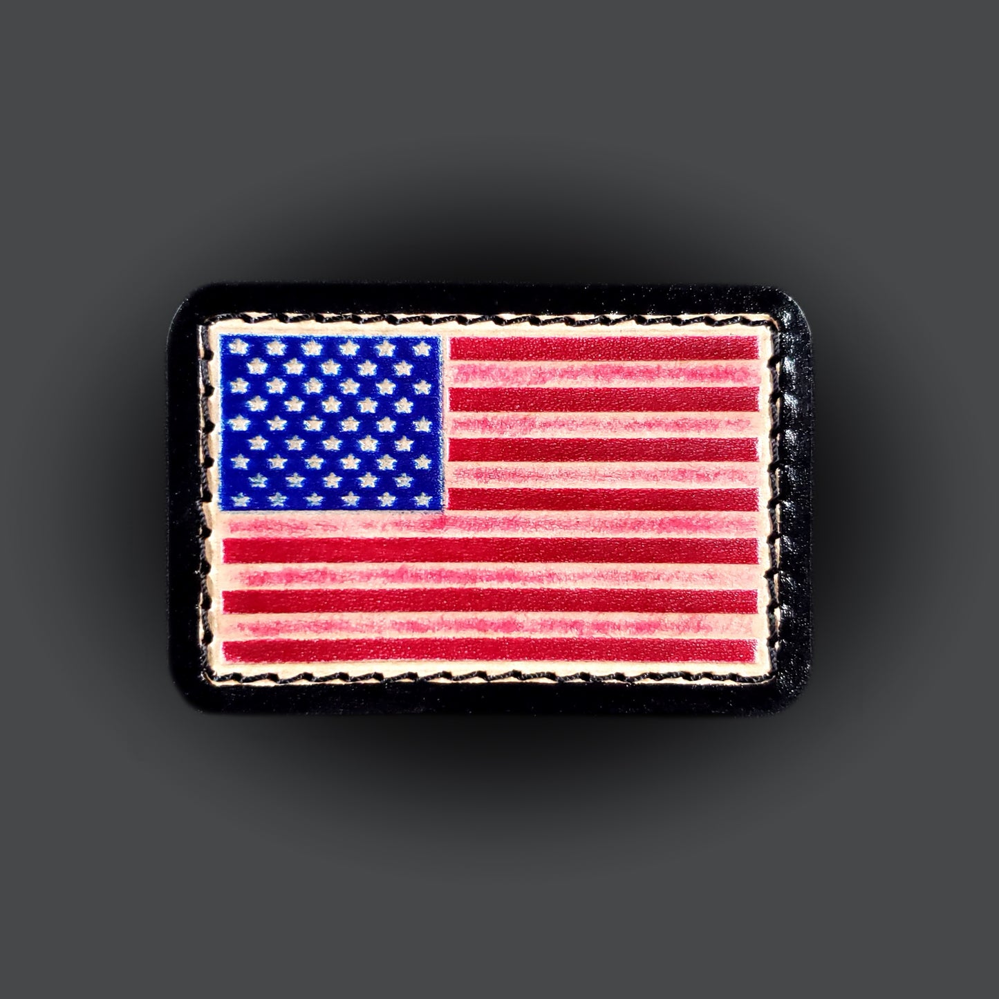 Red, white, and blue rectangular velcro patch embossed with the American flag, on a grey background.