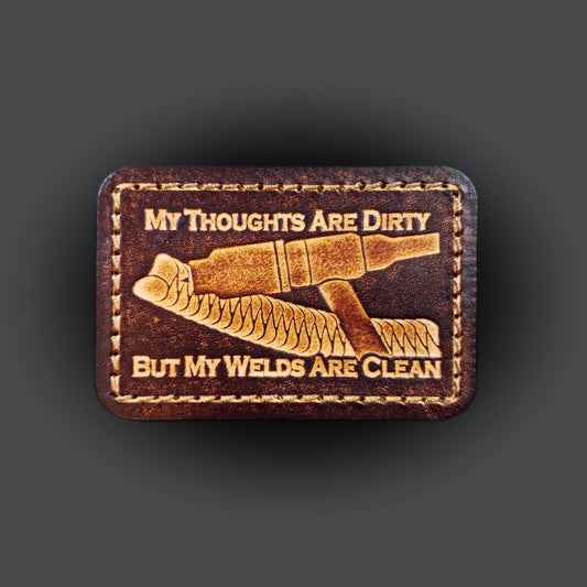 Brown rectangular velcro patch embossed with a picture of a welding tig torch and text that says "My thoughts are dirty, but my welds are clean".