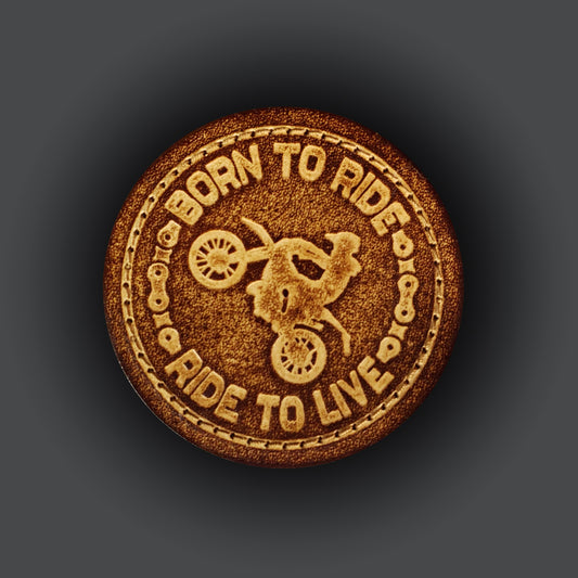 Brown circular velcro patch embossed with a graphic of a motorcyclist and text that says "Born to ride, Ride to live".