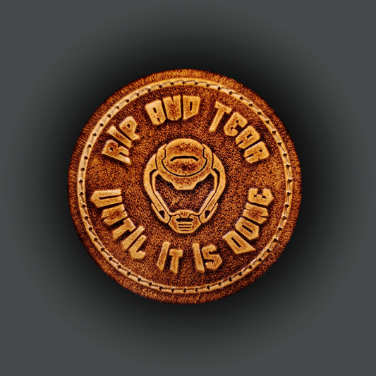 Brown leather velcro patch embossed with text that says "Rip and tear until it is done" and a helmet from the Doom franchise.