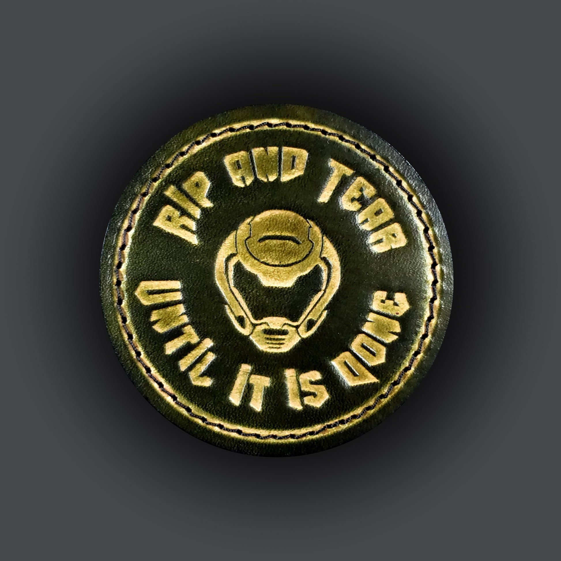 Green leather velcro patch embossed with text that says "Rip and tear until it is done" and a helmet from the Doom franchise.