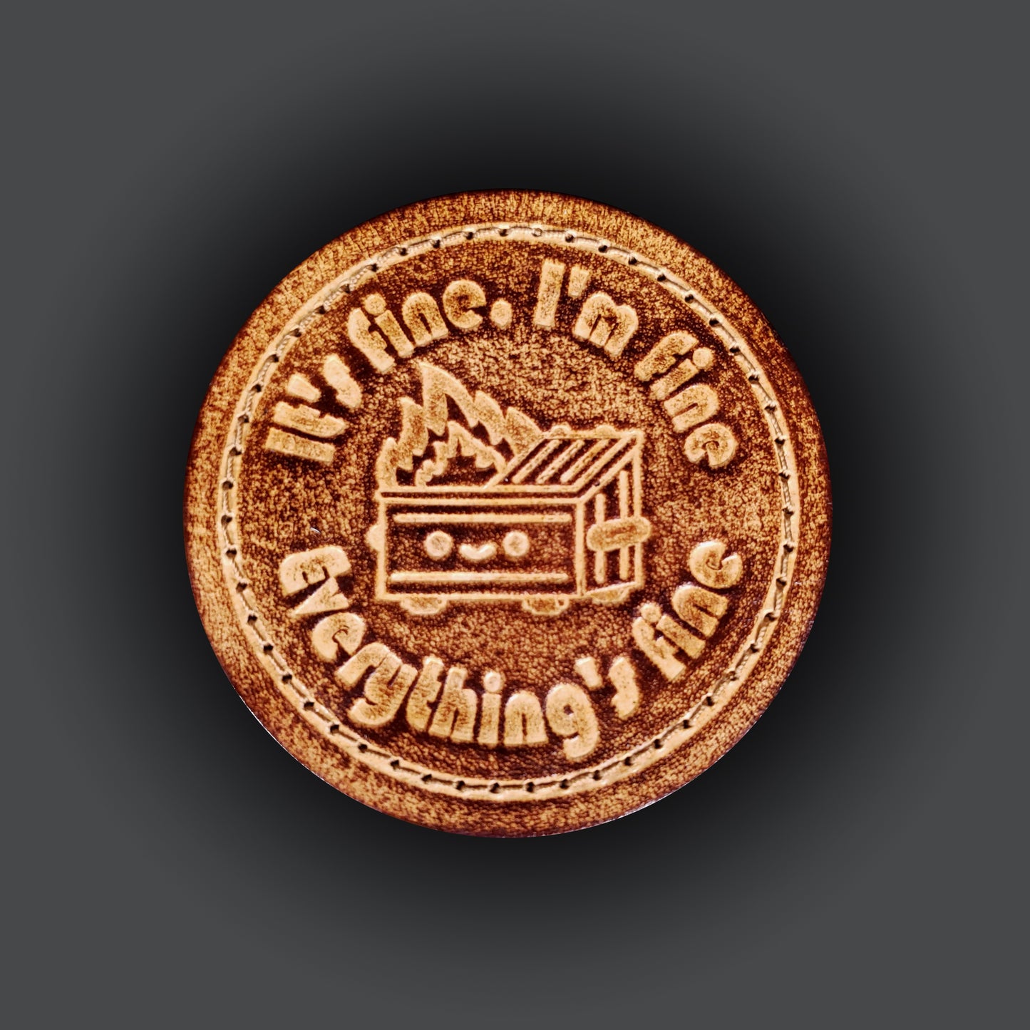 Brown leather velcro patch featuring a graphic of a smiling dumpter on fire, and text that says "It's fine, I'm fine, Everything's fine".