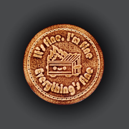 Brown leather velcro patch featuring a graphic of a smiling dumpter on fire, and text that says "It's fine, I'm fine, Everything's fine".