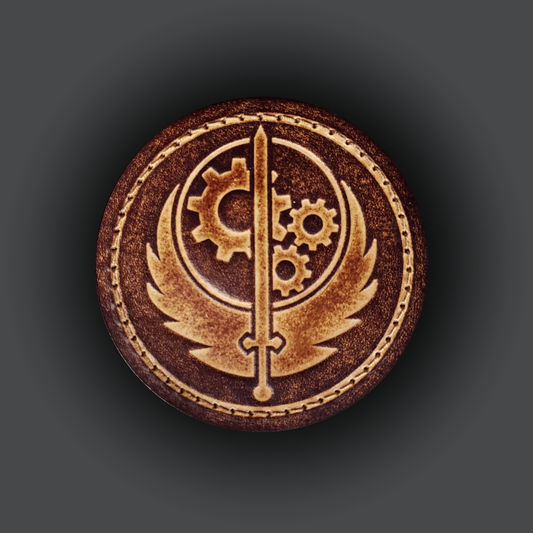 Brown circular velcro patch embossed with the Brotherhood of Steel emblem from the Fallout franchise.
