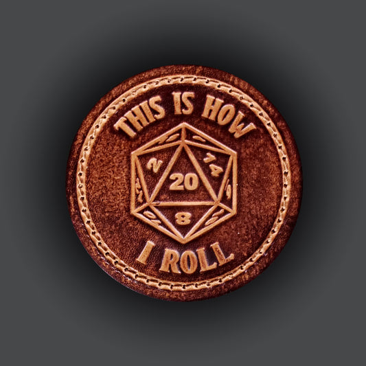 Brown leather velcro patch with text that says "This is how I roll" and an image of a twenty sided die with the number twenty facing up.
