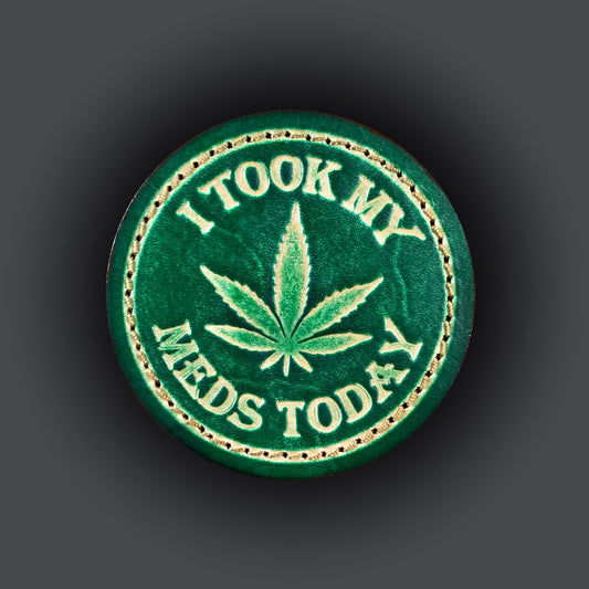 Green leather velcro patch embossed with a five leaf plant and text that says "I took my meds today".
