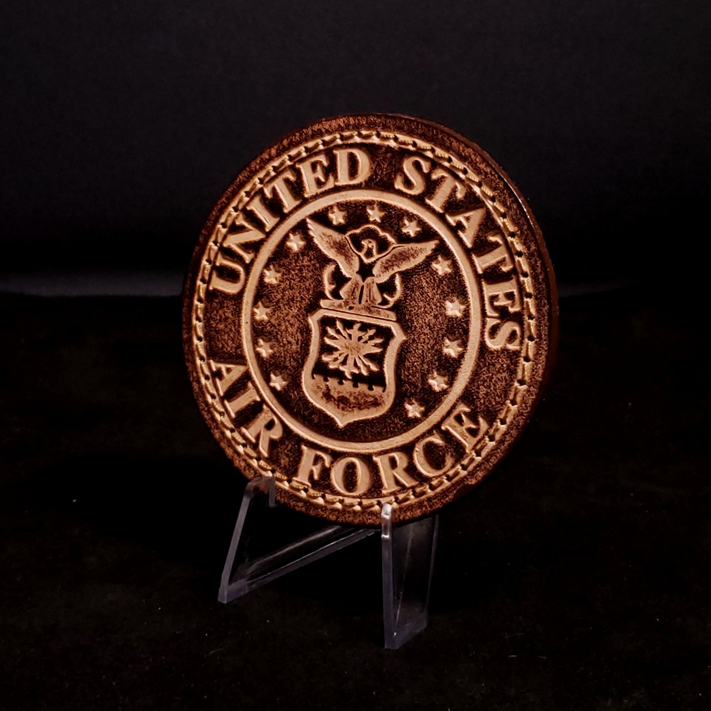 Brown leather velcro patch embossed with text and the United States Air Force emblem, posed on a black background.