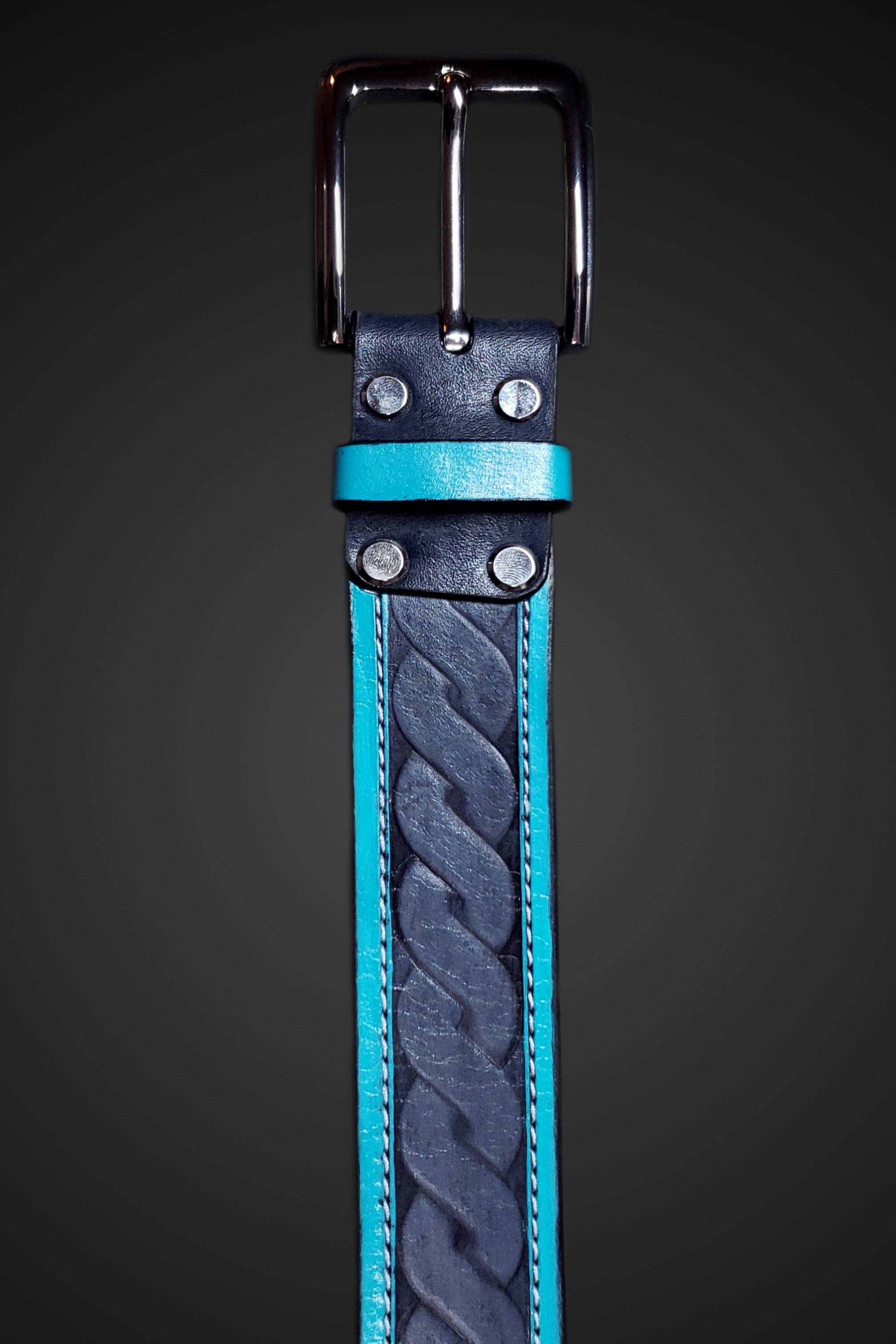 A light blue and grey leather belt with an embossed spiral pattern and a silver buckle