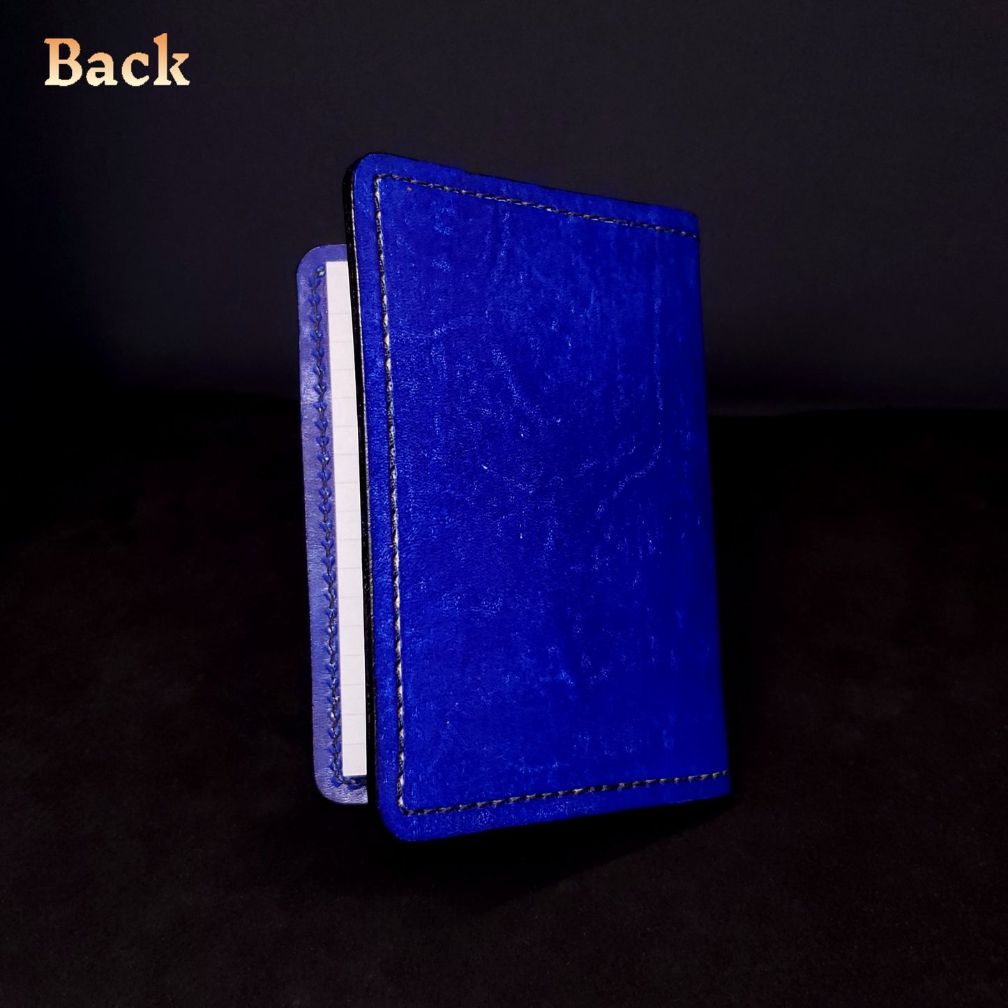 Blue leather mini-composition cover, closed and viewed from the back