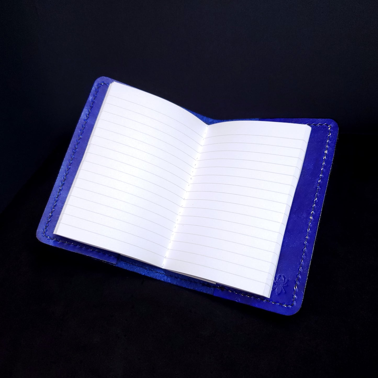 Blue leather mini-composition cover, opened with lined pages