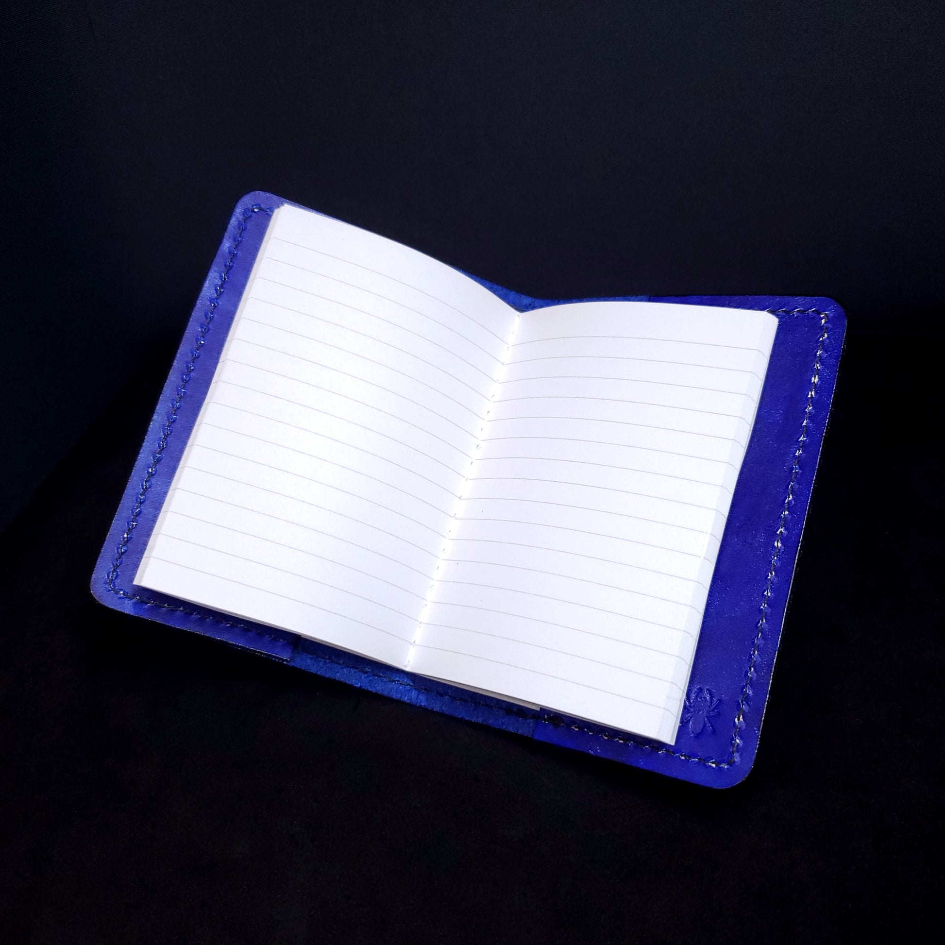 Blue leather mini-composition cover, opened with lined pages