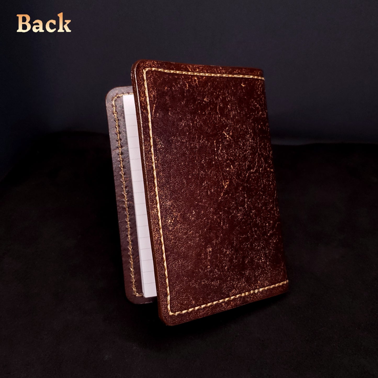 Brown leather mini-composition cover, closed and viewed from the back