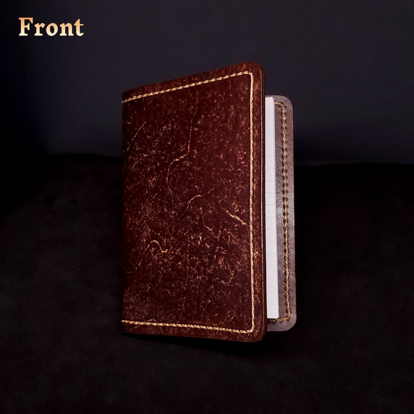 Brown leather mini-composition cover, closed and viewed from the front