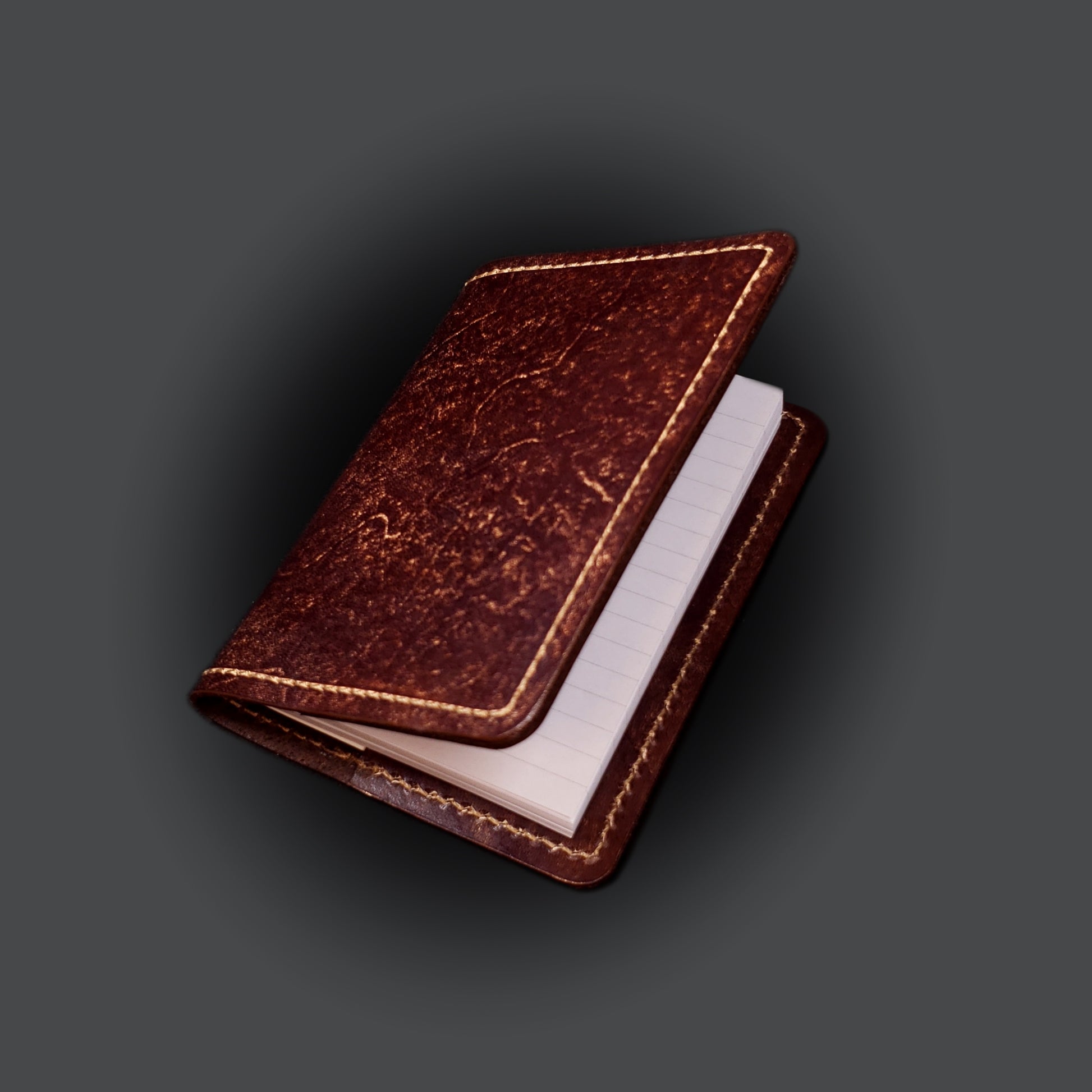 Brown leather mini-composition cover on a grey background