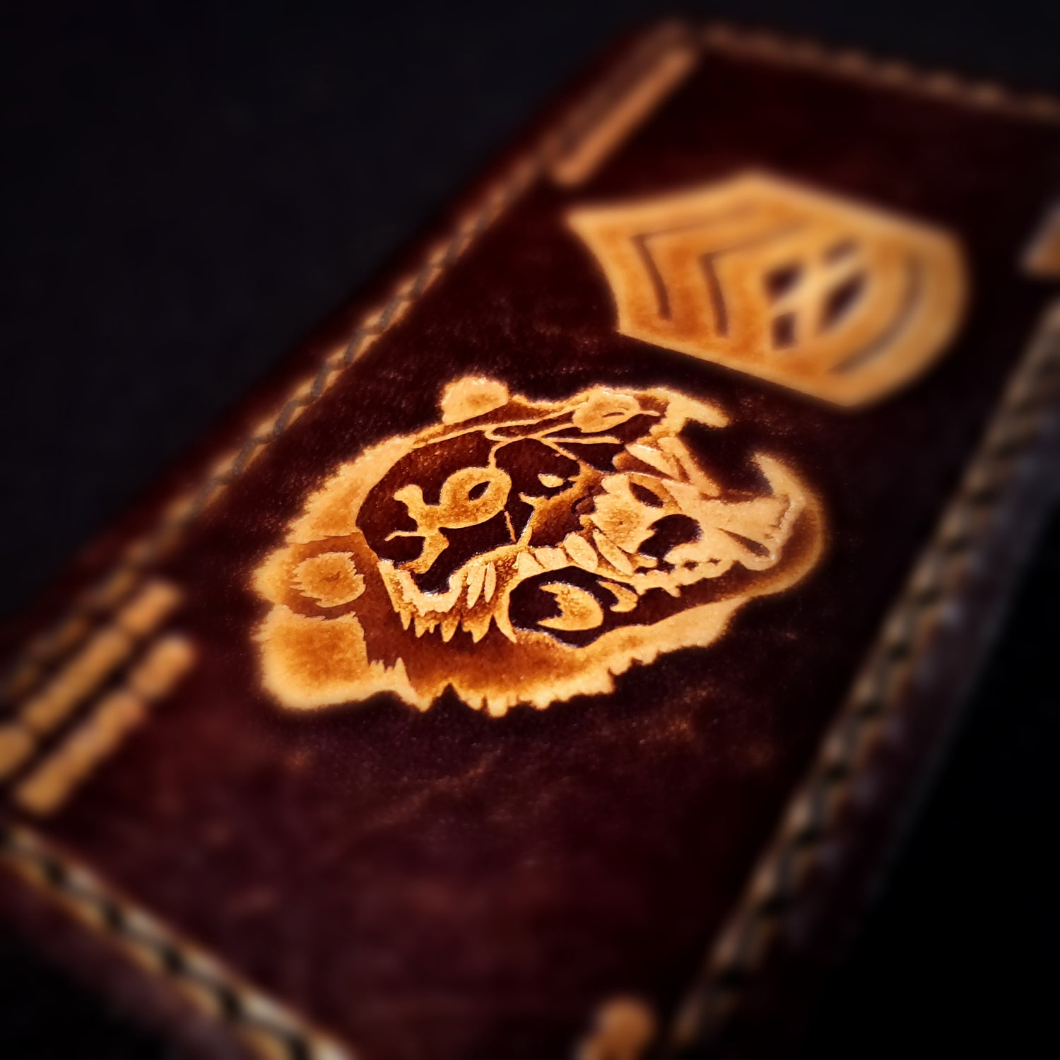 Close-up of a leather velcro patch embossed with a detailed zombie bear skull.